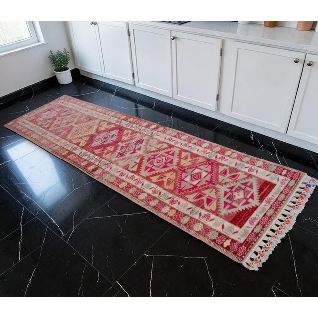 This exceptional hand-knotted runner, originating from the weaving traditions of Eastern Anatolia during the 1970s,...