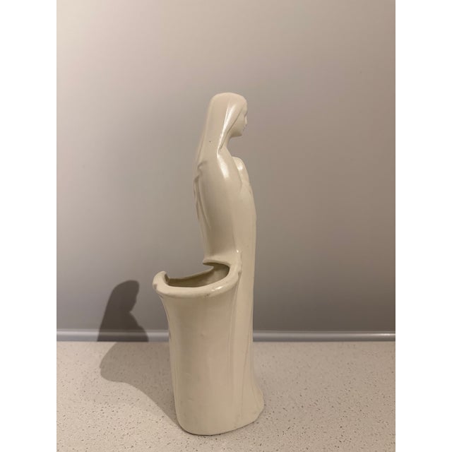 Vintage American ceramic Madonna planter featuring a beautifully stylized depiction of the Virgin Mary with hands clasped...