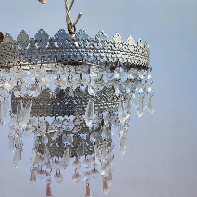 pair of vintage metal chandeliers with glass drops Height: 110 Width: 30 This piece is attributed to the mentioned...