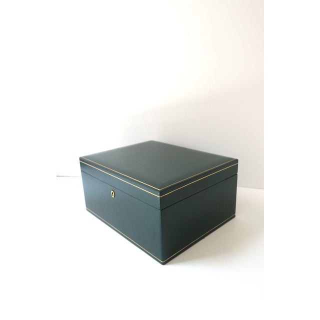 An Italian dark‑green leather jewelry box with gold embossing, tan suede interior, and three removeable trays, circa...