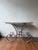 This 1880 French Butcher Table combines a sturdy stone top with aged iron legs, reflecting authentic and industrial charm....