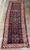 Dating to approximately 1900, this antique Caucasian runner is a handwoven wool rug representing the richly patterned...