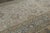 Hand-knotted in wool and originating circa 1900-1920, this 11x18 distressed antique Persian Mashad rug is an exceptional...