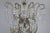 Monumental Italian 24 light crystal beaded arm chandelier adorned with garlands of crystal swags, crystal spheres, and...