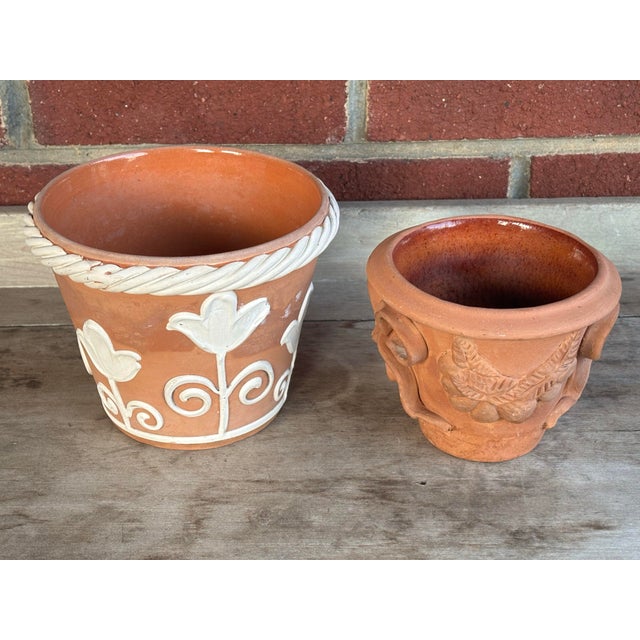 1970s Italian terracotta planter pot pair. The larger planter has white rope surround with tulips. The smaller Vietri...
