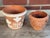 1970s Italian terracotta planter pot pair. The larger planter has white rope surround with tulips. The smaller Vietri...