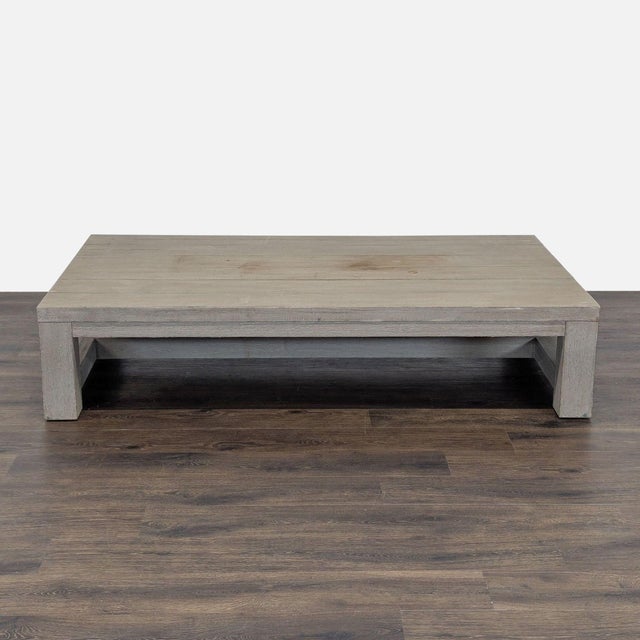 This Restoration Hardware coffee table features a clean, modern design with a sturdy, rectangular shape. Crafted in a...