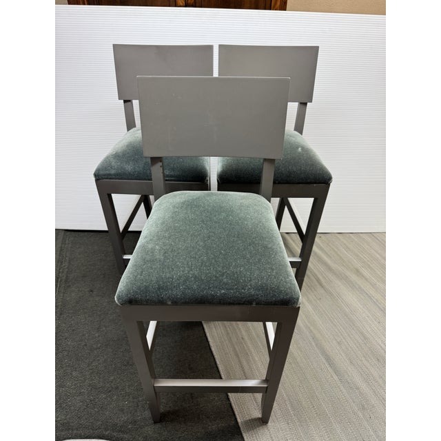 Design Plus Gallery presents a Custom Set of Three Barstools. Crafted from woods in a mudd gray stain. The seats are...