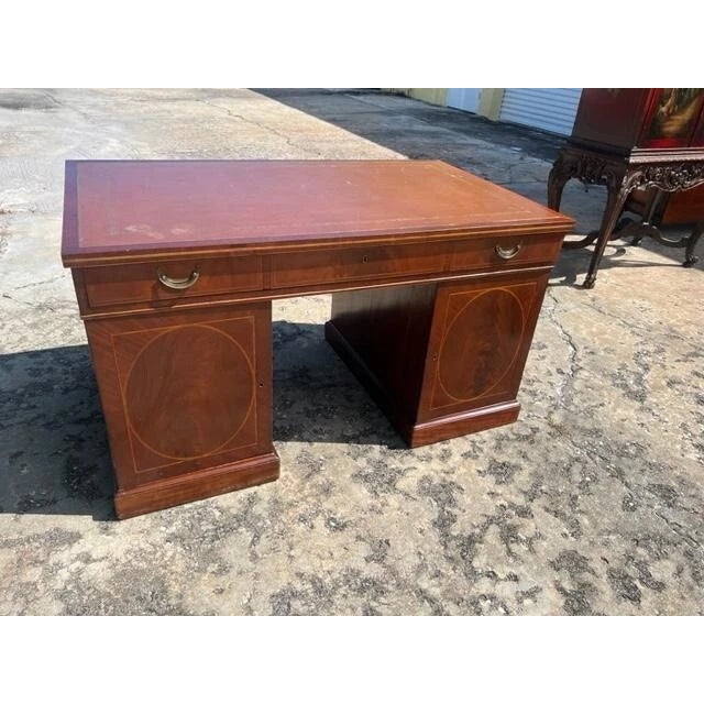 This is a beautifully crafted antique English partner desk made of premium Mahogany with intricate inlays. The desk...