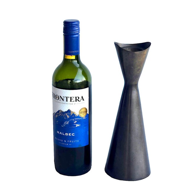 Offered is a chic and sleek bronze candle holder in the style of iconic Danish mid 20th century teak wood tulip...