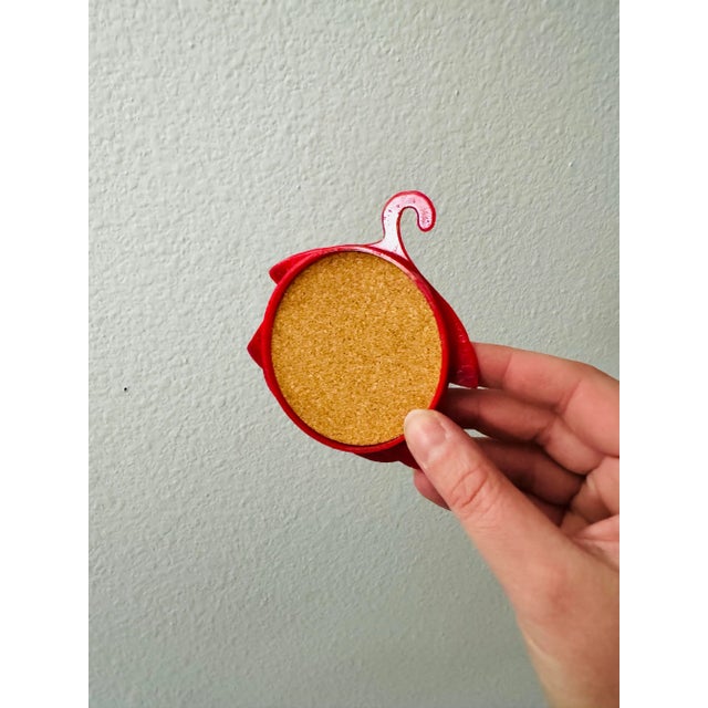 A playful set of drink coasters designed to mimic hanging clothes, by Victor Goldman, showcasing a vivid palette of mid-...