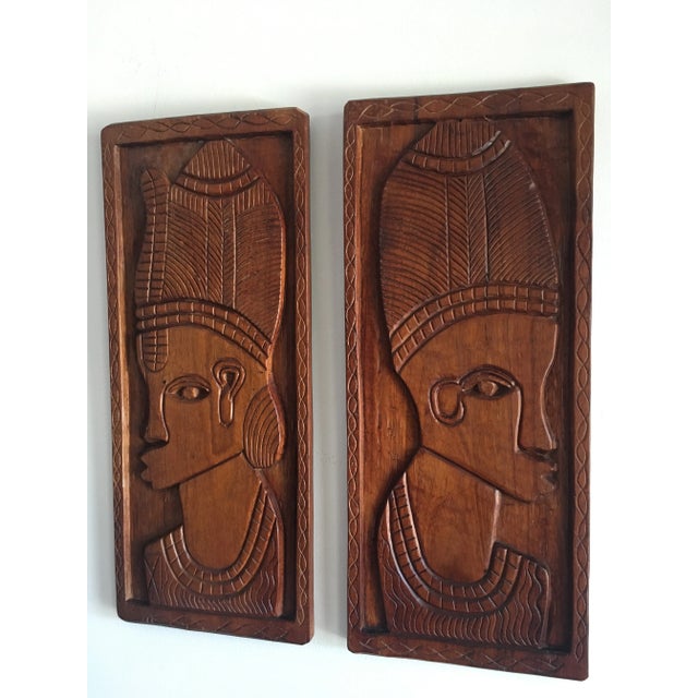 Pair vintage African tribal carved relief plaques. Solid heavy wood with a beautiful rich color.
