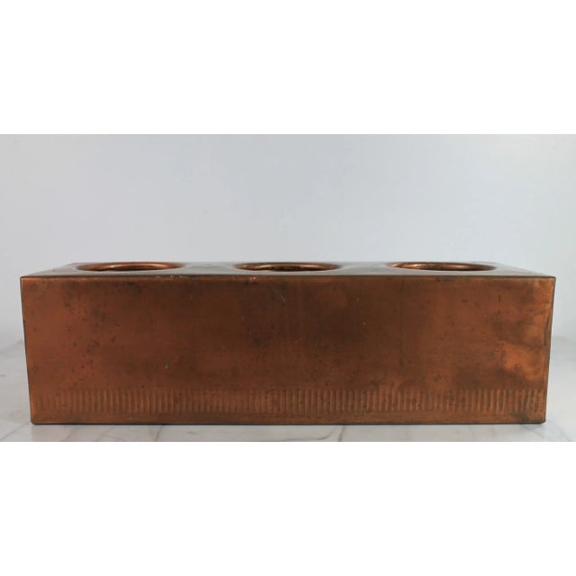 Vintage copper wine bottle holder with ribbed detail on bottom edge. No makers mark. Some patina. Holds 3 bottles. Each...