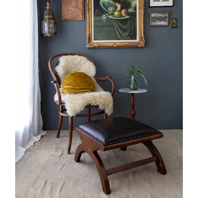 This leather and rosewood X frame ottoman or footstool features a dark espresso brown leather with a braided crosshatch,...