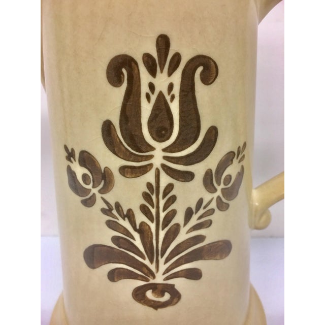 Mint condition. Not one issue. This is a wonderful tall pitcher in the Village Brown collection. A warm yellow maize color...
