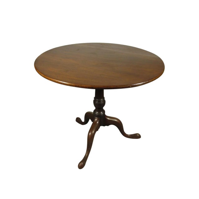 An 18th-C. American Chippendale tea table with solid mahogany top, original brass catch, and rich original patina.