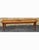 A Mid-Century American Classical Pine Bench. Structurally sound. Measures 60" in width, 11.5" in depth and 17.5" in height.