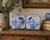 A classic pair of Dutch Delft-style hand painted blue and white Delft ceramic tiles featuring farm landscapes and...