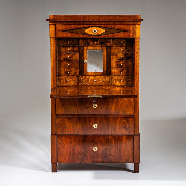 Biedermeier secretary with three drawers, fall-front writing surface and top drawer with diamond panel and inlaid velarium...
