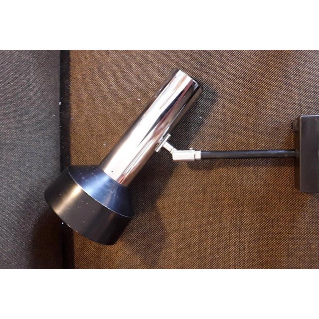 Vintage German Adjustable Wall Spotlight in Black Plastic & Chrome-Plated Metal from Staff, 1970s, in Good conditions....
