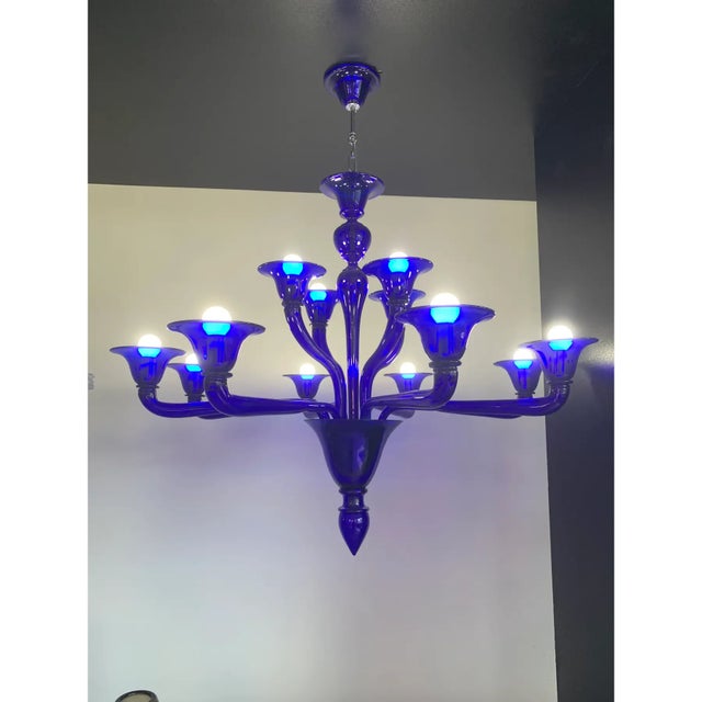 Contemporary Murano glass chandelier in decò style decorated in very lively and sparkling electric blue which makes it...