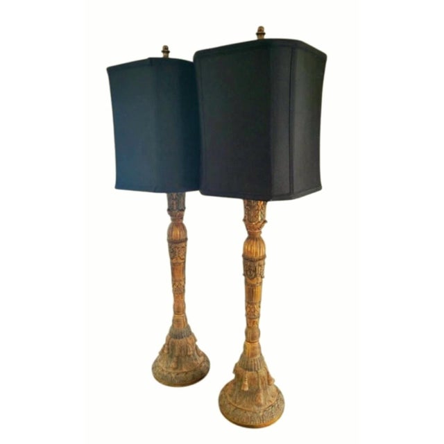 Make a dramatic, glamorous statement with this striking pair of tall Hollywood Regency buffet lamps. Featuring intricately...