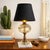 A charming mid‑century accent lamp featuring a luxe blend of white marble, ribbed clear glass, and warm brass detailing....