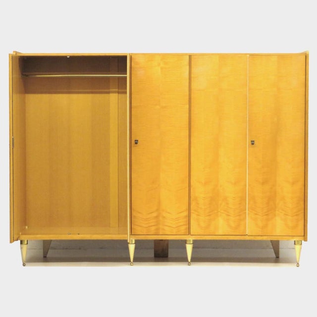 Large vintage 5-door wardrobe in flamed maple. This mid century modern wardrobe is equipped with stylish legs finished...