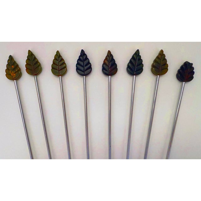 Swizzle in style with this set of 8 bakelite and stainless steel stirrers. Carved bakelite leafs are slightly transparent,...
