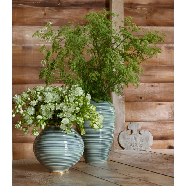 The cool gray of the Calinda Vases bring a contemporary look to a room. The round vase adds interest, and its low...