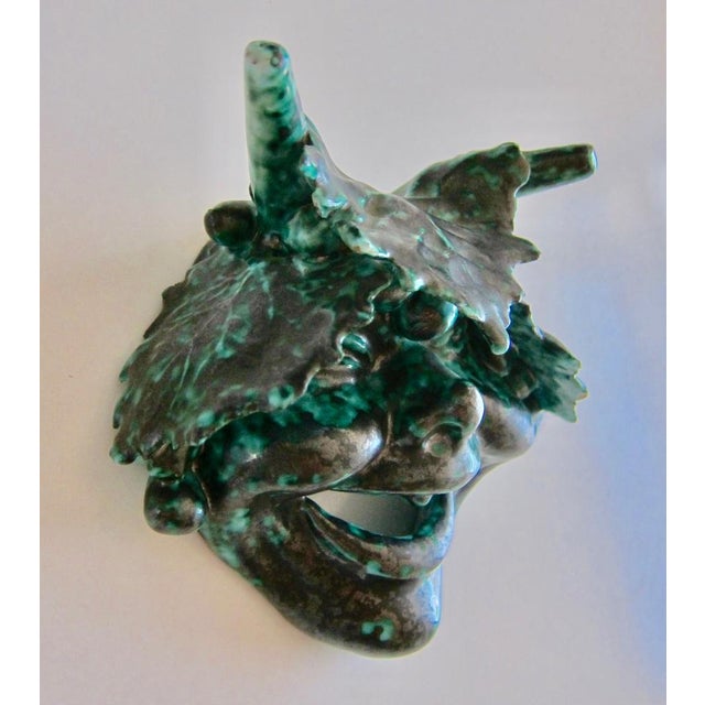 Cute small ceramic mask representing a faun. Great green glaze so representative of the period. Dimensions: 13 cm Height x...