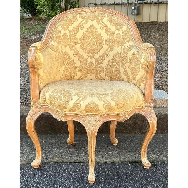 This is a pair of Italian carved and cerused pine French Louis XV style barrel tub chairs. The damask upholstery feels...