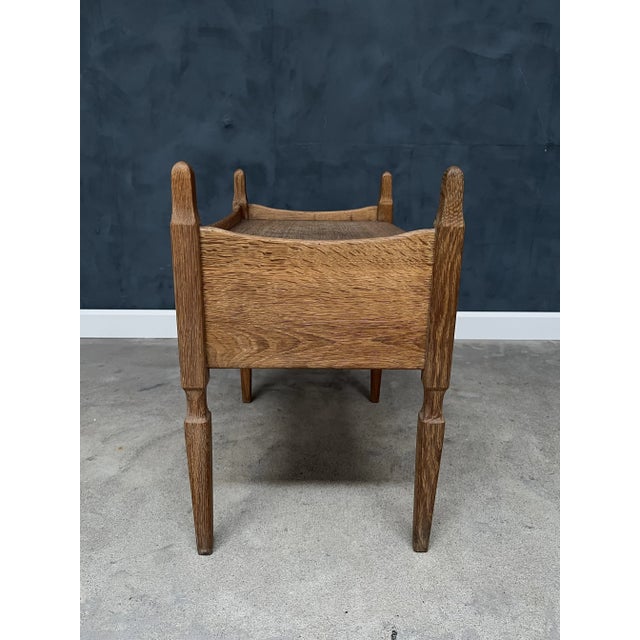 Charming and characterful side table crafted from solid oak, designed by Henning Kjærnulf and produced by Nyrup Møbler in...