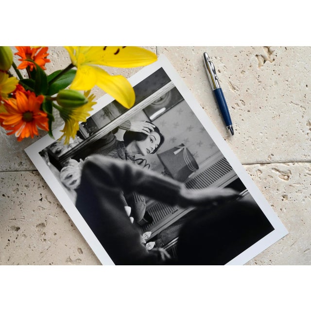 Audrey Hepburn at her dressing room mirror, 1957. 11" x 14" silver gelatin fiber based print signed on verso by the...