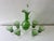 Italian, emerald green glass carafe and six stemmed glasses attributed to Empoli, circa 1960’s. Rope like blown glass...