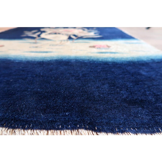 This handmade antique Chinese Peking rug from the 1890s is a refined and highly decorative example of late 19th-century...