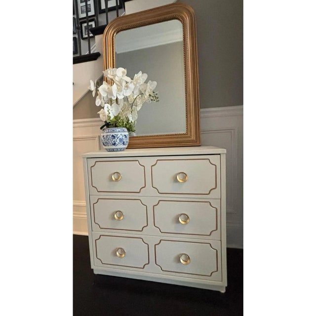Offered is a vintage ivory and gold nightstand chest in the iconic style and manner of Dorothy Draper's Espana model....