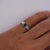 18k white gold bezel set natural emerald solitaire ring and diamond ring jacket. This unique peice seamlesly comes on and...