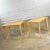 Handsome pair of blonde mid-century modern side tables or end tables with light faux woodgrain laminate tops. They are in...