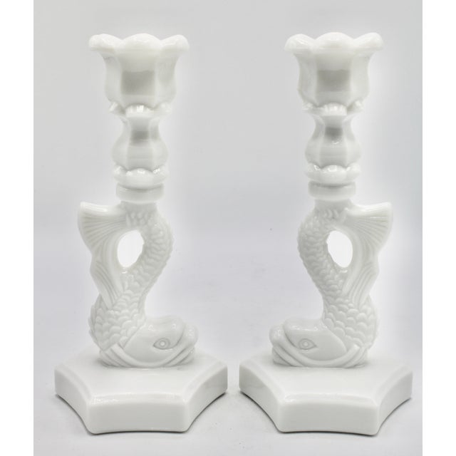 A stunning pair of vintage white milk glass dolphin form candlestick holders, circa 1950s. This is a tall, bright white...