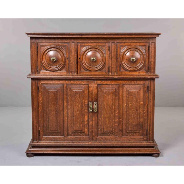 This two-part French oak cabinet is constructed in solid oak with a pine secondary interior and back. The upper section is...