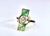 This striking Art Nouveau-style ring showcases a nature-inspired design centered on a bezel-set, old-cut diamond that...