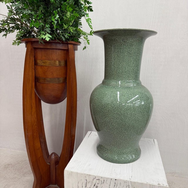 "About This Piece About This Piece A timeless fusion of serenity and craftsmanship, this tall green porcelain vase...