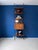 A floor-to-ceiling bookcase from the 1960s, featuring burnished metal uprights and brass end caps. Shaped teak shelves and...