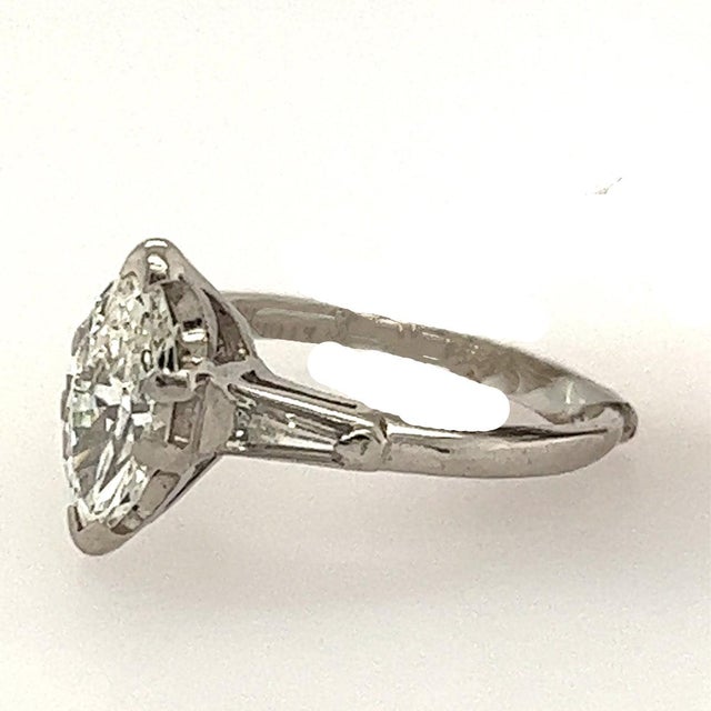 Vintage platinum ring with 0.89 carat GIA certified I color VS1 clarity marquis cut diamond and 2 baguette diamonds...