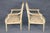 A graceful and beautifully coordinated pair of paint-decorated Louis XVI-style bergère armchairs, distinguished by their...