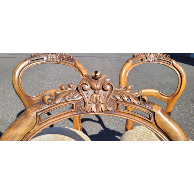 A beautiful set of six French Walnut hand carved balloon back 19th century side chairs. Each chair features shaped balloon...