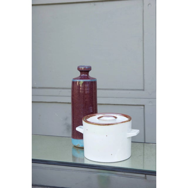 Decorative set of two modern glazed Scandinavian vessels. The tall pottery vase marked "Kragten," the lidded ceramic jar...