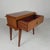 This handy little table also serves as a small cabinet. It features a drawer and angled, tapered legs—typical of mid-...
