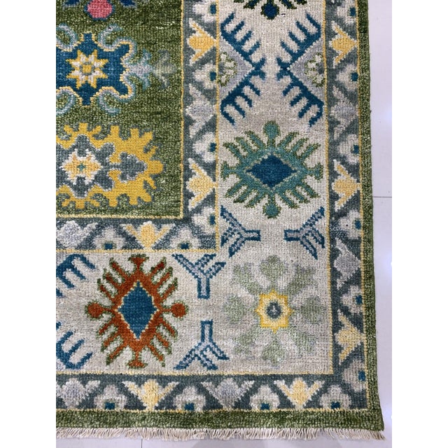 Inviting Kazak Light Green Hand Knotted Wool Rug, Country of Origin: India. This exceptional hand-knotted piece draws...